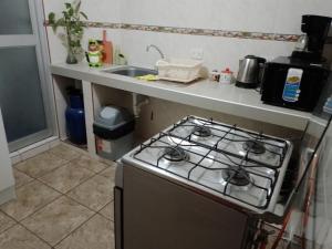 a kitchen with a stove and a sink at Private Apartment in San Luis VIDENA in Lima +24 photos