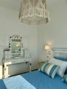 a bedroom with a bed and a television on a table at thEros - apartment 2 in Parikia +38 photos