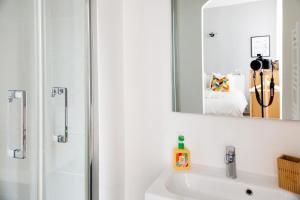 a bathroom with a shower and a sink with a mirror at Maison Sylvabelle - Confort d'exception - Quartier des Antiquaires - in Marseille +21 photos