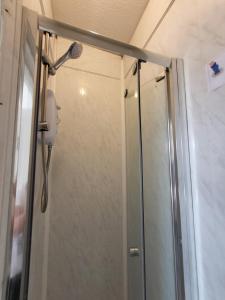 a shower with a shower head in a bathroom at Marvellous property for 8 people in Battersea - Zone 1, 3 min walking from the main Station in London +27 photos