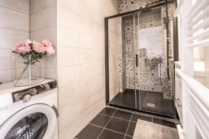 a bathroom with a shower and a washing machine at Smart Monaco Holiday, 6 Pax, Bnb Rickeys in Beausoleil +9 photos