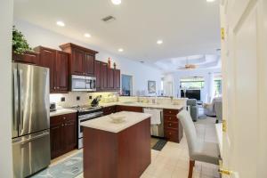 a kitchen with wooden cabinets and stainless steel appliances at Lakefront, Private Pool, Irynas Dream in Bradenton