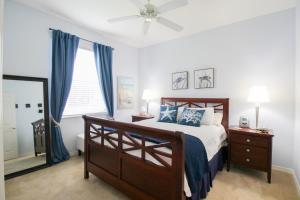 a bedroom with a bed and a ceiling fan at Lakefront, Private Pool, Irynas Dream in Bradenton +52 photos