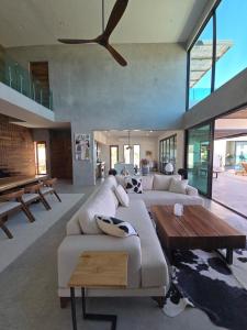 a living room with two couches and a table at New 5BR-6BTH Lap Pool, Pickleball, Jacuzzi Sauna ,Cold Plunge, Gym, Bocce in El Sargento +53 photos