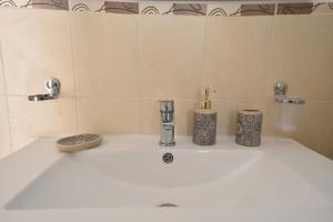 a bathroom sink with three candles on it at Sud Casa Vacanze in Ragusa +18 photos