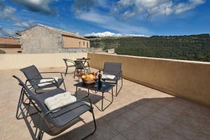 a patio with chairs and a table on a roof at Sud Casa Vacanze in Ragusa