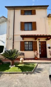 a house with a cat sitting in front of it at La casa dar braschi in Il Prato