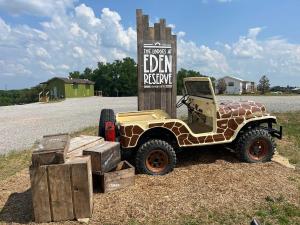 a jeep parked in front of a sign at Block of 4 Lodges at Eden Reserve - For Groups in Williamstown