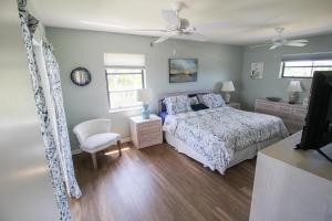 Un dormitorio con una cama y un ventilador de techo. en Spacious 3BR pool home on Sanibel Island - 10 min walk to beach, en Ybel 34 fotos más