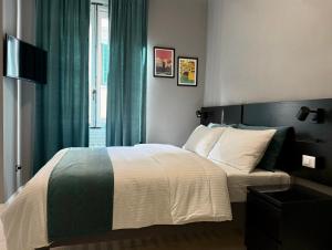 Posteľ alebo postele v izbe v ubytovaní San Frediano Boutique
