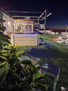 a backyard of a house at night with a hot tub at Casa Senderos del Norte in Sauzal