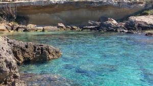a pool of blue water in a river with rocks at B&B Eco Dal Mare in Gallipoli