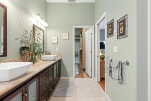 a bathroom with a sink and a mirror at Tranquil 2BR lakefront home in Palmer Ranch in Sarasota +18 photos