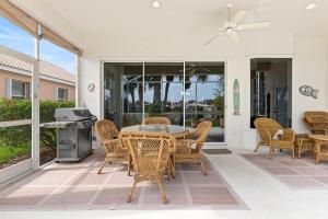 a patio with a table and chairs and a grill at Tranquil 2BR lakefront home in Palmer Ranch in Sarasota