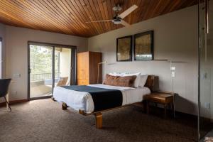 a bedroom with a bed and a sliding glass door at Architects Dream Home - Secluded Mountain Retreat in Golden