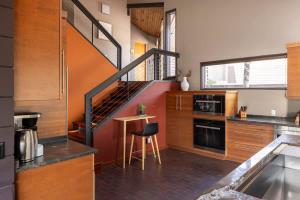 a kitchen with a staircase in the middle of it at Architects Dream Home - Secluded Mountain Retreat in Golden
