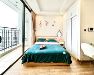 a bedroom with a large bed and a balcony at Lux Studio Apt, Modern Amenities, 2 Minutes To Walking Lake, Swimming Pools And Gym in Hanoi +88 photos