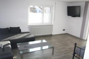a living room with a couch and a coffee table at Ferienwohnung Hengl in Ettenheim
