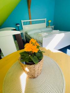 a basket with flowers on a table in a bedroom at Rodinný penzion Bavlnka in Německé
