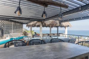 a table and chairs with the ocean in the background at Casa Salita in Sayulita