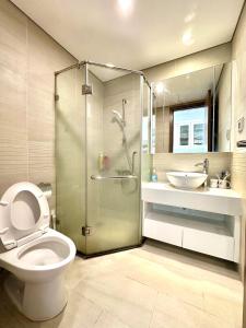 a bathroom with a shower and a toilet and a sink at Deluxe Studio Apt Next Nation Convention Centre and Keangnam in Hanoi