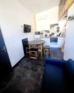 a kitchen and dining room with a table and chairs at Maison 4 couchages in Saint-Léger-sous-Brienne