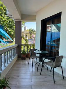 a patio with a table and chairs on a balcony at Casa MIA in Cabarete