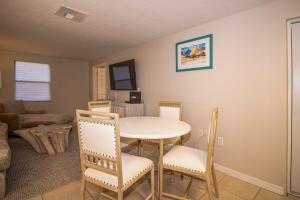 a living room with a table and chairs at Charming Manasota Key duplex with beach access- IB14 in Englewood