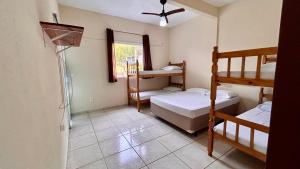 a room with two bunk beds and a window at Suites Oceano in Caraguatatuba