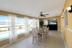 ポート・シャーロットにあるSerene Private Pool Home In Port Charlotteのテーブルと椅子と窓のあるダイニングルーム