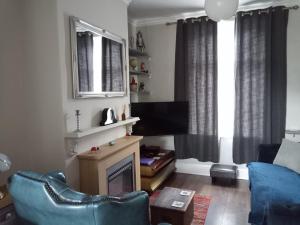 a living room with a couch and a television at Pankhurst, Louth in Louth