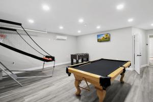 a pool table in a room with a net at Private pool home with game room - Shaker Of Salt in Sarasota