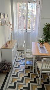 a dining room with a table and chairs and a window at La Casa di Klaudia in Rome