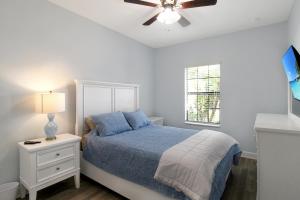 a bedroom with a bed and a ceiling fan at Gorgeous lakefront home in Esplanade Golf & Country Club in Lakewood Ranch in Bradenton +61 photos