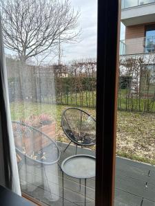 a view of two chairs and a table from a window at Apartament 777 in Gdynia