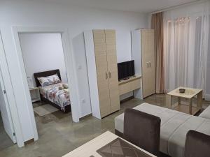 a living room with a bed and a television at Prenoćište SILVER LUX Srebrno Jezero 13 in Veliko Gradište