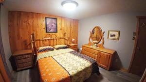 a bedroom with a bed and a mirror and a dresser at Cottage with inground pool outside in Saint-Damien +47 photos