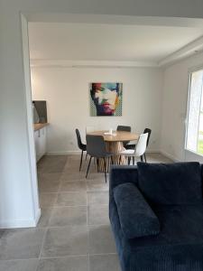 a living room with a couch and a table and chairs at Casa San Stefanu in Olmeta-di-Tuda +12 photos