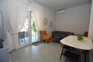 a living room with a table and a couch at IRON House in Kavála