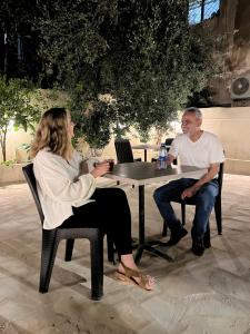 a man and a woman sitting at a table at Downtown Inn Madaba in Madaba