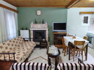 a living room with a couch and a table at Agiasos House in Agiásos