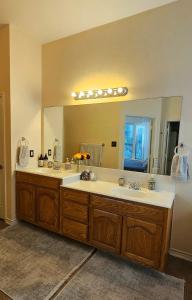 a bathroom with two sinks and a large mirror at Lovely Lakeside Living in Rockwall +42 photos