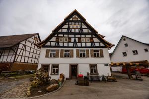 a house with a black and white building at Wohnen im Denkmal. Erholung pur. in Sulz am Neckar
