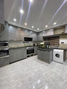 a large kitchen with a stove and a dishwasher at Tastefully Furnished four bedrooms katampe in Abuja +17 photos