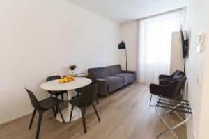 a living room with a couch and a table and chairs at appartamento lussuoso sul porto di Cagliari in Cagliari