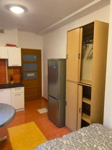 a kitchen with a stainless steel refrigerator and cabinets at Arkuszowa 58 Studio 15 in Warsaw