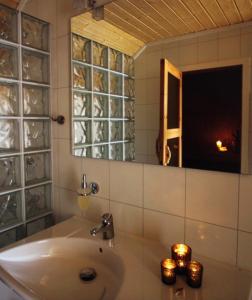 baño con lavabo, espejo y ventana en Nordkappferie, en Gjesvær