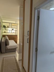 a living room with a couch and a mirror at Sanja apartman in Bar