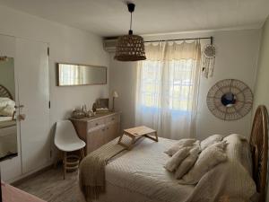 a bedroom with a bed and a table and a chair at Villa golfe de St Tropez in Cogolin +20 photos