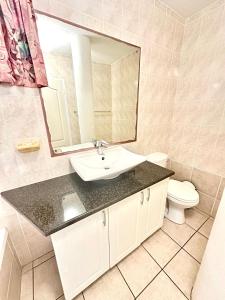 a bathroom with a sink and a mirror and a toilet at Boulevard Margate in Margate +9 photos